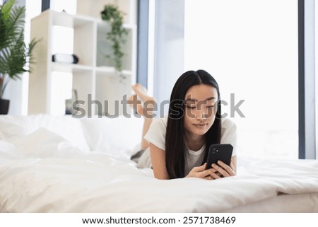 Similar – Image, Stock Photo Woman in her twenties with electric scooter recording voice note with a smartphone outdoors.