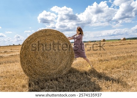 Similar – Image, Stock Photo Woman Pushing Hay Bale