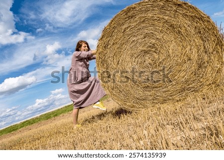 Similar – Image, Stock Photo Woman Pushing Hay Bale