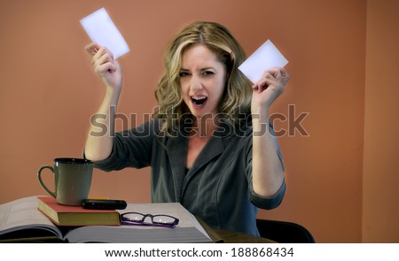 Beautiful Woman Frustrated Working or Studying at a Table