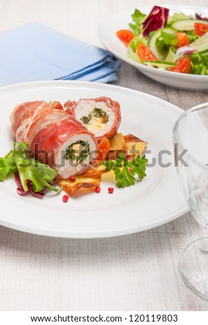 chicken breast wrapped in parma ham stuffed with gorgonzola and herbs served with baked potatoes