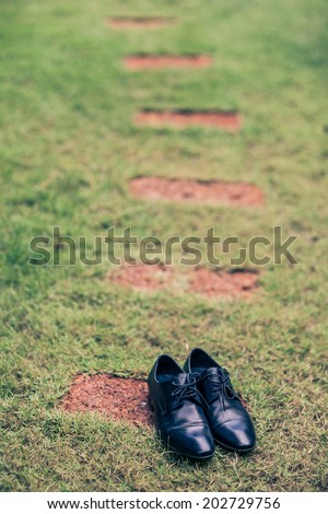 Groom Shoes Black on on the lawn