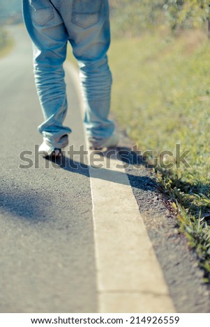 People walking a straight line on the road