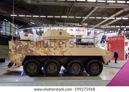 PARIS, FRANCE - JUNE 17, 2014: People visit stands at Eurosatory, the largest international land and air-land defence and security exhibition in Europe..