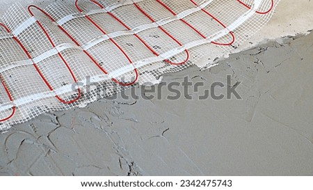 installation of an electric cable underfloor heating on the floor under a cement screed close-up, copy space Foto stock © 