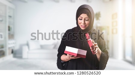 Similar – Image, Stock Photo Young arab woman opening a box with products while smiling, concept retail and buying online