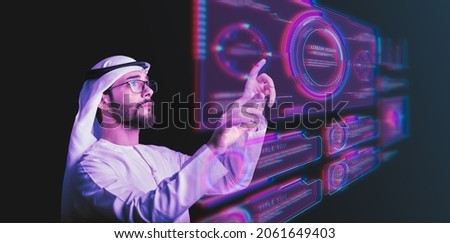 Arab man using hologram, Futuristic user interface concept. Graphical User Interface(GUI). Head up Display(HUD). Internet of things.