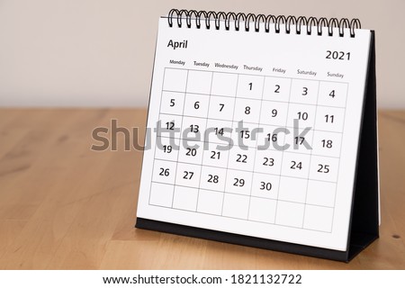 Month page: April in 2021 paper calendar on the wooden table