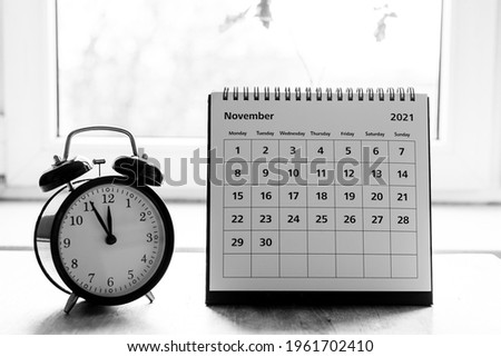 November 2021 grayscale calendar - month page showing date on wooden table 商業照片 © 