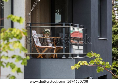 Exterior - balkony close up picture with table, chair and flowers. Nice relaxing place Zdjęcia stock © 