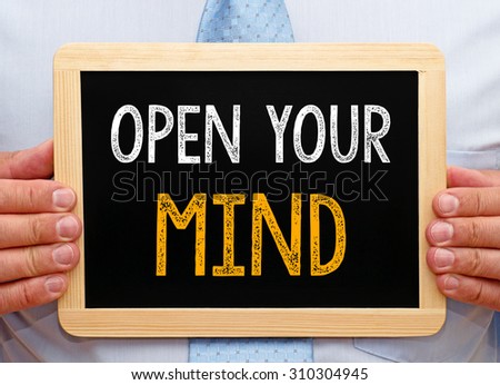 Open your mind - Businessman holding chalkboard with text