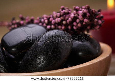 hot massage stone in a bowl with potpourri