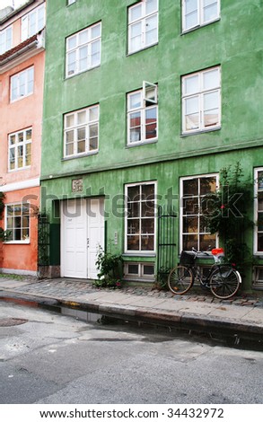 Colorful town houses in street in Copenhagen. pavement with bike and apartments or flats