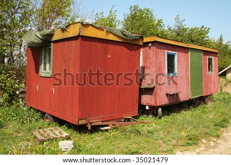 workman\'s trailer or caravan. small red mobile home wagon of wood