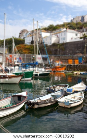 Fishing boats in harbor in cornish village of Mousehole. Cornwall English holiday destination with water and maritime vessels in port