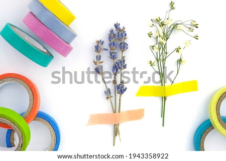 Set of paper sticky tape on a white background. Colored self-adhesive tape for decoration. Decorative adhesive tape for hobby. Small bouquet of dry lavender and gypsophila glued to paper, herbarium 