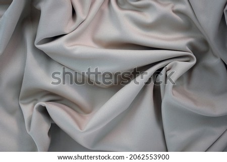 Draped canvas close-up. Abstract polyester fabric background. Top view of fabric with many folds. waves of satin material, shiny texture.  ストックフォト © 