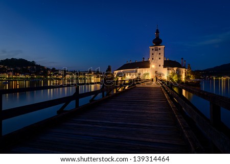 Lake castle (Schloss Ort),Traunsee lake with Gmunden city in background at night.  Austria