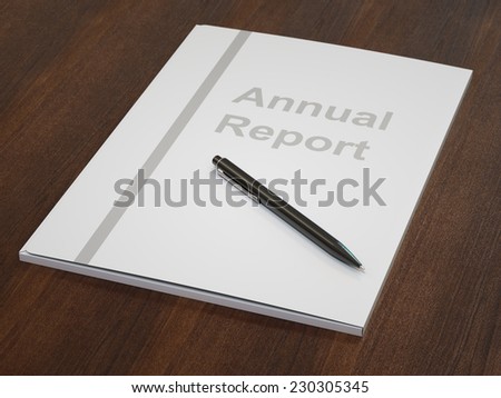 White annual report folder with black pen on dark wood table close-up