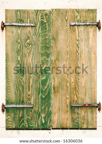 Window of a Mediterranean house with wooden shutters