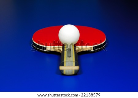 Symmetry of a table tennis. Racket and ball on blue table.