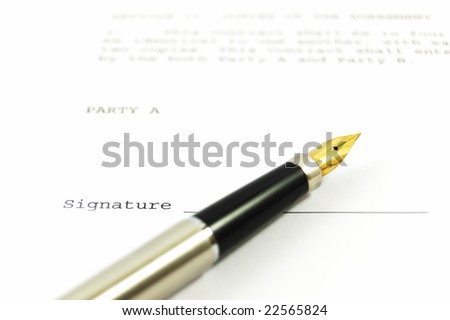 A gold-nibbed pen on a form of a document with a place for a signature