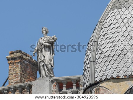 Odessa, Ukraine - July 19, 2015: Statue of a woman, the goddess with a wreath and ears of wheat. On the roof of the apartment building in the city. Odessa, July 19, 2015