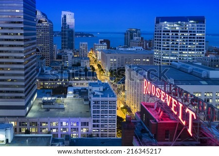 SEATTLE, WASHINGTON AUGUST 8. Faint, predawn light illuminates this aerial view of downtown Seattle with the historic Roosevelt Hotel sign, Pine street to Pike Place Market and Elliott Bay.