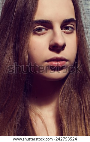 Close up portrait of young beautiful woman. Light-brown long hair . Natural makeup. Fashion model shooting.