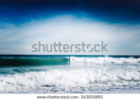 Surfer is having fun on the huge wave