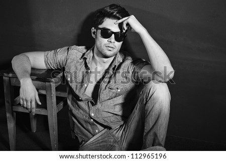 Vintage stylized black and white photo of young male model (Photo has an intentional film grain)
