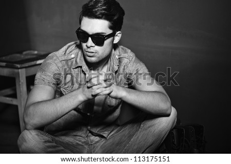 Sexy man looking cool - vintage stylized black and white photo (Photo has an intentional film grain)