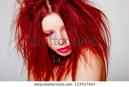 portrait of sexy red haired woman, wild hair style - beauty shoot in the studio