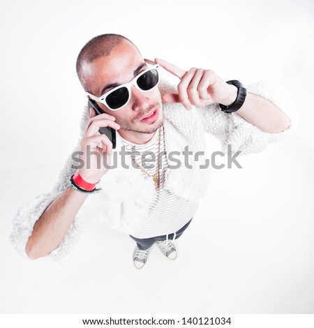 funny guy wearing fur and hipster glasses while talking on the phone