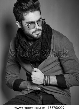 sexy fashion man model dressed casual posing dramatic in the studio