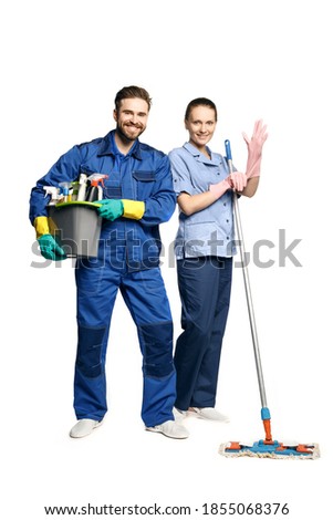 A young bearded smiling man in the uniform of a janitor holds a basket with moisturizing products, and maid-shaped women. Isolated on a white Foto stock © 