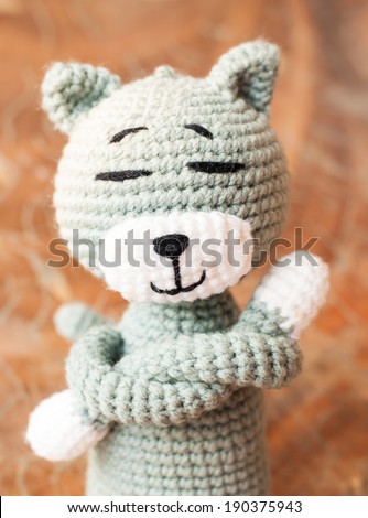 Knitted toy tabby cat isolated on white background