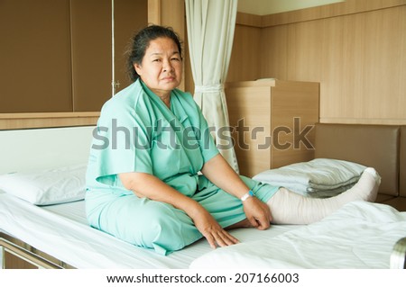 senior woman with broken leg in hospital