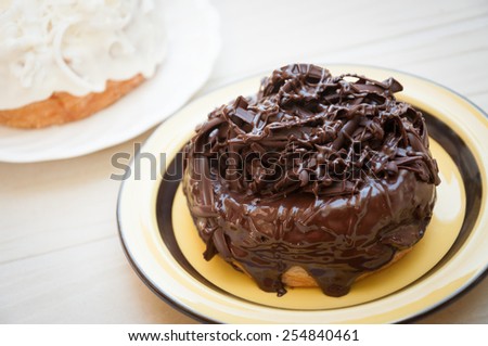 Half-donut and half-croissant pastries, chocolate, white chocolate, Traditional French puff doughnuts pastries with chocolate and topping, cronut