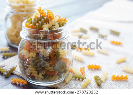 Bow tie pasta in mason jar on wooden board
