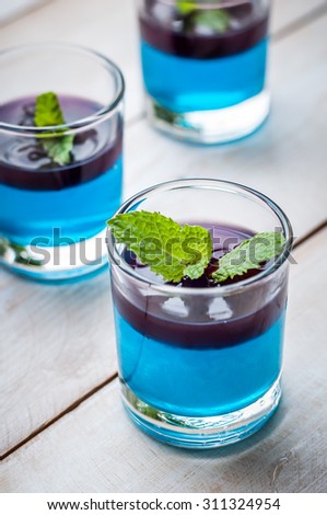 blue hawaiian with blueberry panna cotta dessert on white wooden board