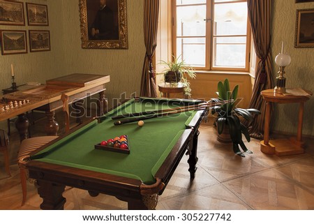 Rozumberk Castle (south of Prague), Czech Republic - August 2, 2015: Pool or billiard table and other games in Biedermeier style interior from beginning of 19. century.Life style of rich of that time.