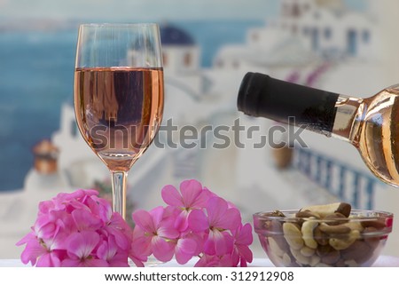 Summer still life with wine and flowers by the sea at Greece island.