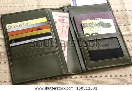 A leather case carrying important travel documents such as air ticket,passport,cash and credit cards.