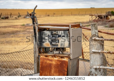 Similar – Image, Stock Photo Old dilapidated fuel pump for liquid fuel in detail with reflection of a blue oh so environmentally friendly xyz car