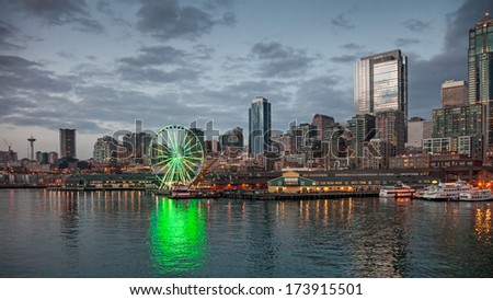 Seattle, USA, JANUARY 2014: Skyline of Seattle in the evening. One office building has its office lights on showing the number 12, supporting the Seahawks for the upcoming match. January 18, 2014