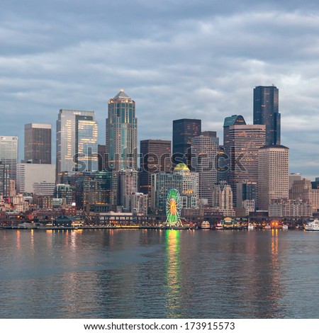 Seattle, USA, JANUARY 2014: Skyline of Seattle in the evening. One office building has its office lights on showing the number 12, supporting the Seahawks for the upcoming match. January 18, 2014