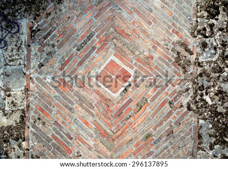 Stone pavement texture. Granite cobblestoned pavement background. Abstract background of old cobblestone pavement close-up. Brick wall background