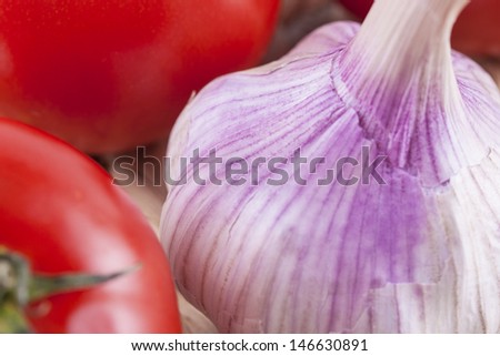 Close up picture of health vegetables - tomato and a garlic bulb