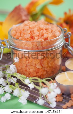 Aromatherapy and relaxation - colorful orange bath salt in a glass